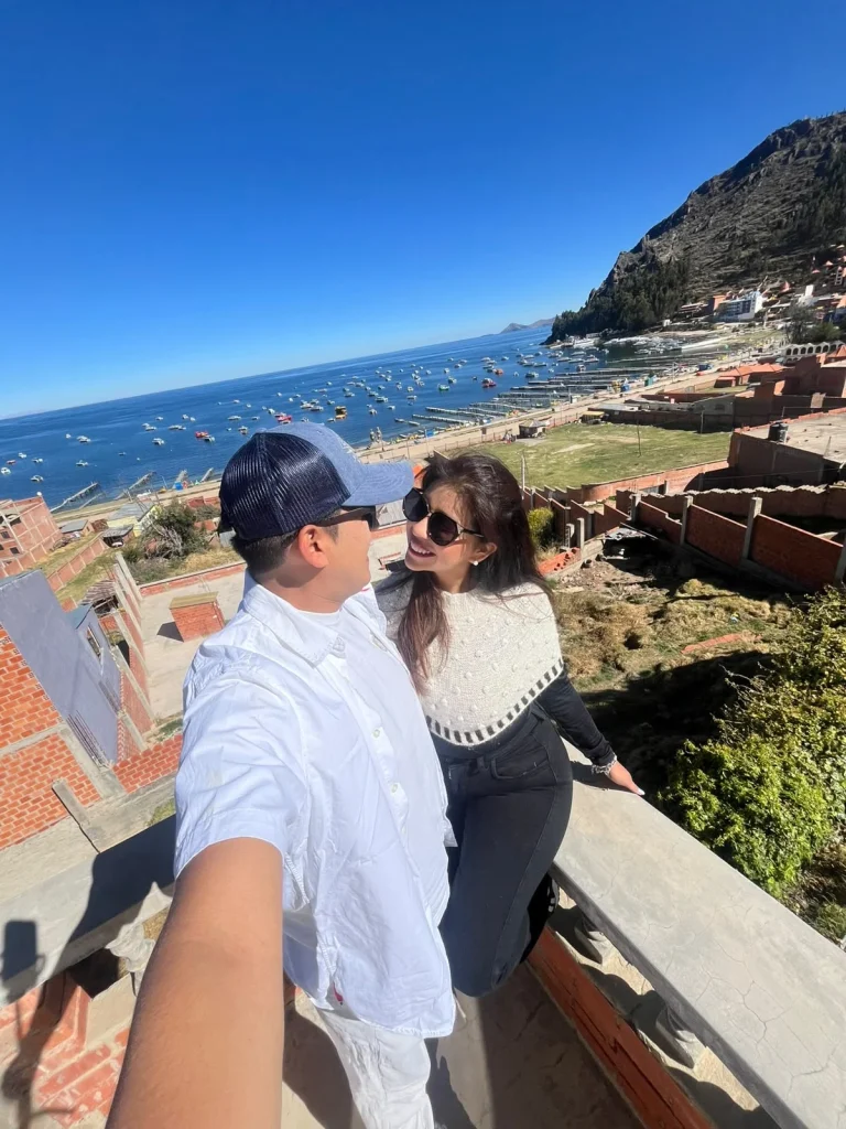 Paul y Carito en una terraza con vista a la bahía de Copacabana y los botes del lago Titicaca