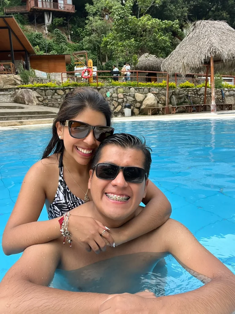 Paul y Carito en la piscina de un alojamiento rodeado de vegetación