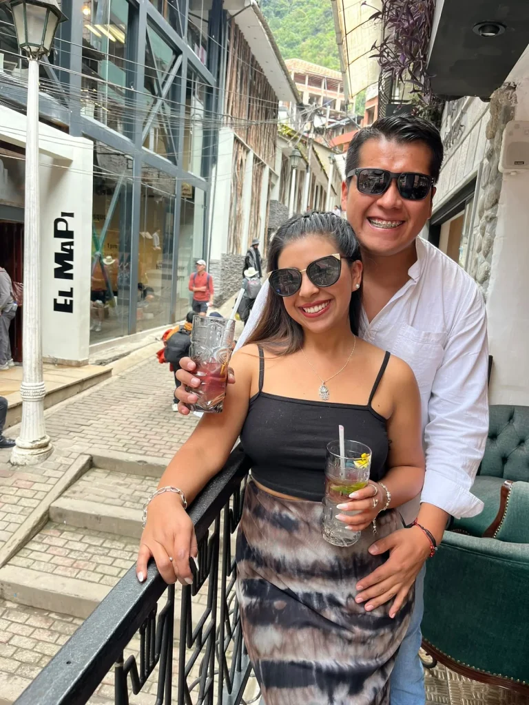 Paul y Carito con bebidas en una terraza de Machu Picchu Pueblo